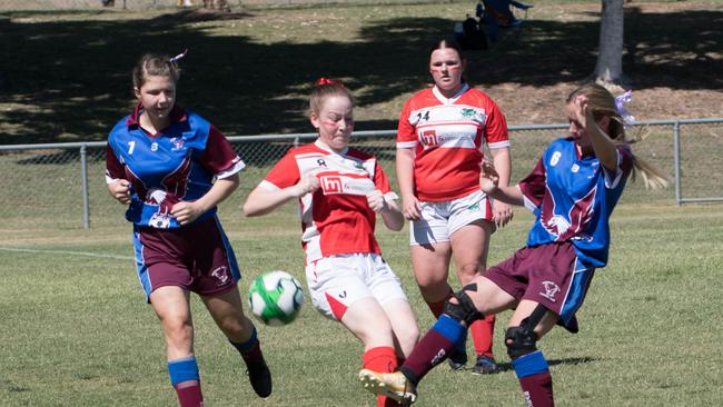 Players from Brisbane Valley (blue strip) and Blackstone battle for possession in the under 15/16 girls Queensland Christian Soccer Association grand final. Picture: Gary Reid