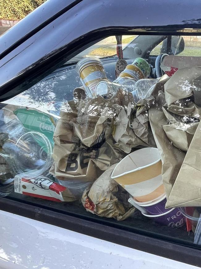 The white MG hatchback had rubbish stacked so high it blocked visibility into the passenger window. Photo: Malcolm Cleary-Polzin/Facebook