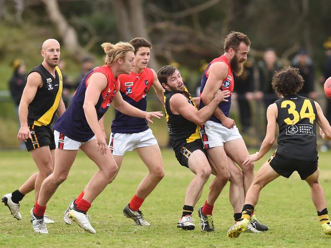 Mt Eliza’s Dan Gormley is tackled. Picture: Chris Eastman