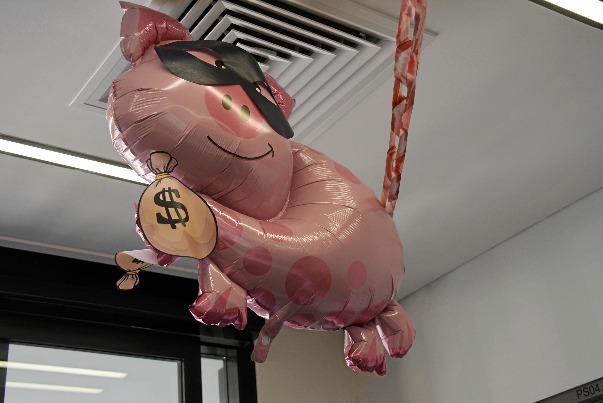 The piggy robber runs from the chief pig at the Kingaroy Police station as part of the Kingaroy Street Window competition. Picture: Jessica McGrath