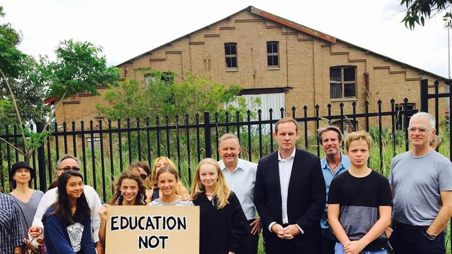 Federal Labor MP for Grayndler Anthony Albanese and former Labor mayor of Leichhardt, Darcy Byrne, outside the old Leichhardt tram sheds, with parents and students of Sydney Secondary College who are concerned the site will be used for a WestConnex tunnel construction site.