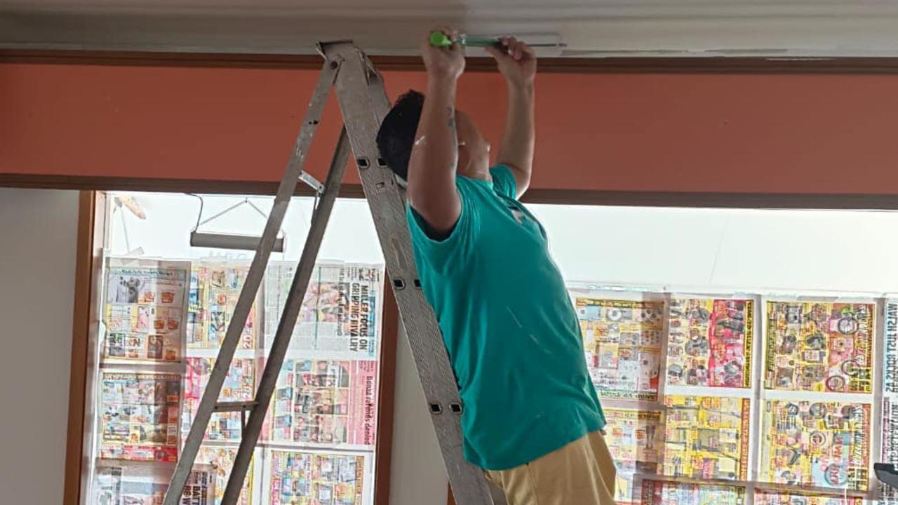 Family and friends help the young couple prepare their cafe for opening.