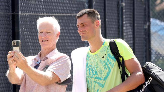 Bernard Tomic poses for a selfie with a fan in Brisbane after his match on Wednesday. Picture: Steve Pohlner