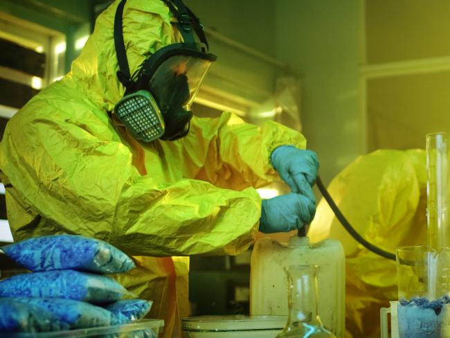 Meth lab generic 2020: In the Underground Drug Laboratory Two Clandestine Chemists Wearing Protective Masks and Coveralls Use Hosepipe For Drug Distillation. They Cook Synthesised Drugs in the Abandoned Building. iStock.