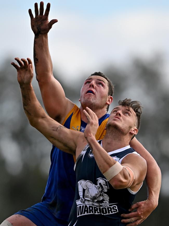 WRFL: Deer Park’s Scott Greenhough climbs over Hoppers Crossing’s Harley Armstrong-Weston. Picture: Andy Brownbill