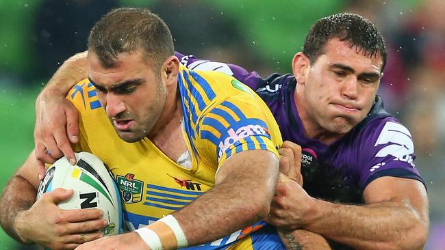 Tim Mannah of the Eels is tackled by Dale Finucane of the Storm during round .