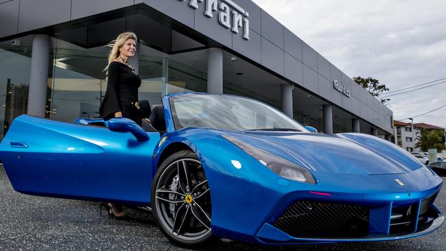 One of the first buyers on the Gold Coast, Marie Nakic standing next to a Ferrari 488 spider at the new Ferrari Gold Coast in Southport. Picture: Jerad Williams