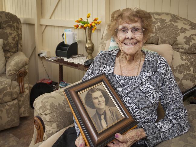 Cecilia Hynes of Maryborough, 102 years of age, holding a photograph of herself when she was aged 18 years.