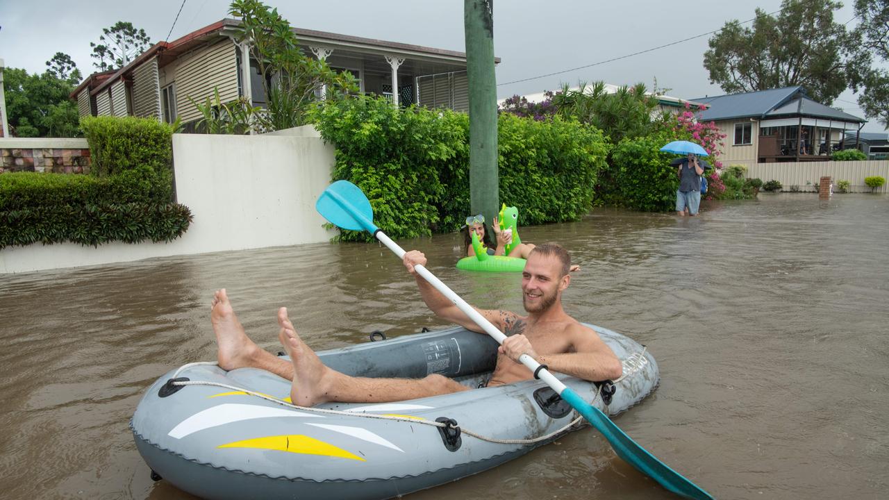 26-02-2022 Flood waters on Sunshine Coast. Bradman avenue residents Steffen dÃ&#149;Atolonia and Lauren Gomes waste time as the Maroochy River rises. Picture: Brad Fleet