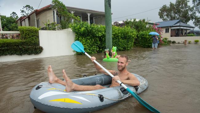 26-02-2022 Flood waters on Sunshine Coast. Bradman avenue residents Steffen dÃ•Atolonia and Lauren Gomes waste time as the Maroochy River rises. Picture: Brad Fleet