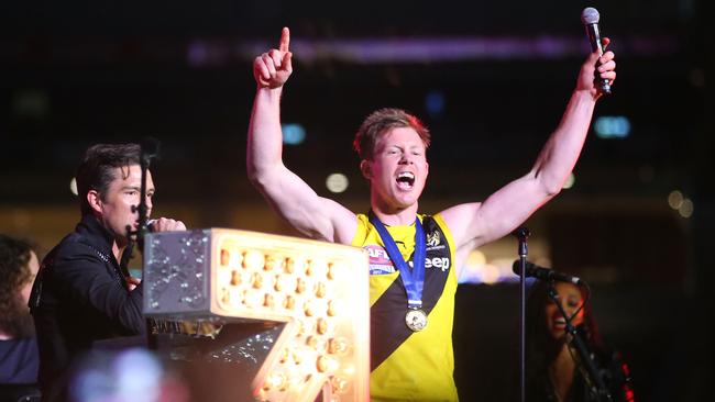 Jack Riewoldt of the Tigers sings on stage with Brandon Flowers and The Killers.