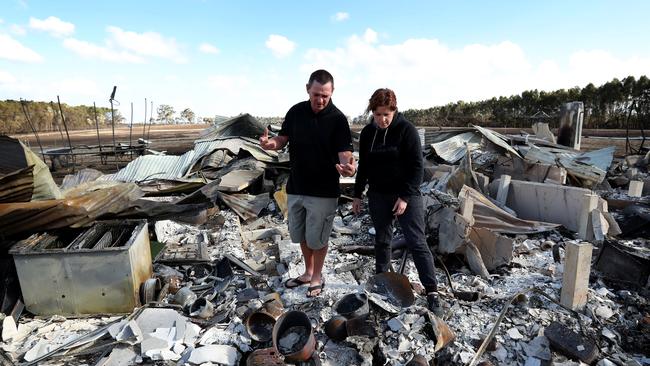 18/03/2018: Phil & Maree Beasley standing in the burnt out remains of their home in Terang, South West Victoria, after a bushfire swept through the area. Stuart McEvoy for The Australian.