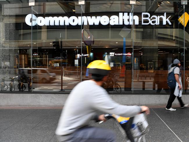 People walk by a Commonwealth Bank (CBA) branch in Brisbane, Thursday, August 3, 2017. The Commonwealth Bank has been accused of a systemic failure to comply with anti-money laundering and counter-terrorism financing laws. The federal government's financial intelligence unit AUSTRAC on Thursday launched civil penalty proceedings in the Federal Court, accusing the lender of more than 53,700 contraventions of law. (AAP Image/Dan Peled) NO ARCHIVING