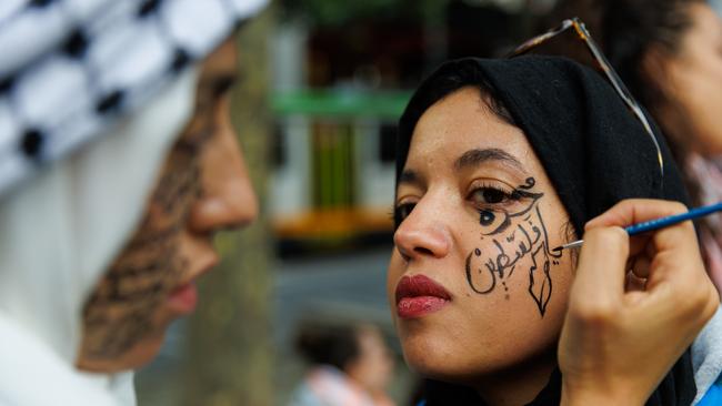 Tasnim Mahmoud Sammak has writing applied to her face in preparation for a pro-Palestinian rally on February 03, 2023 in Melbourne. Photo by Tamati Smith/Getty Images