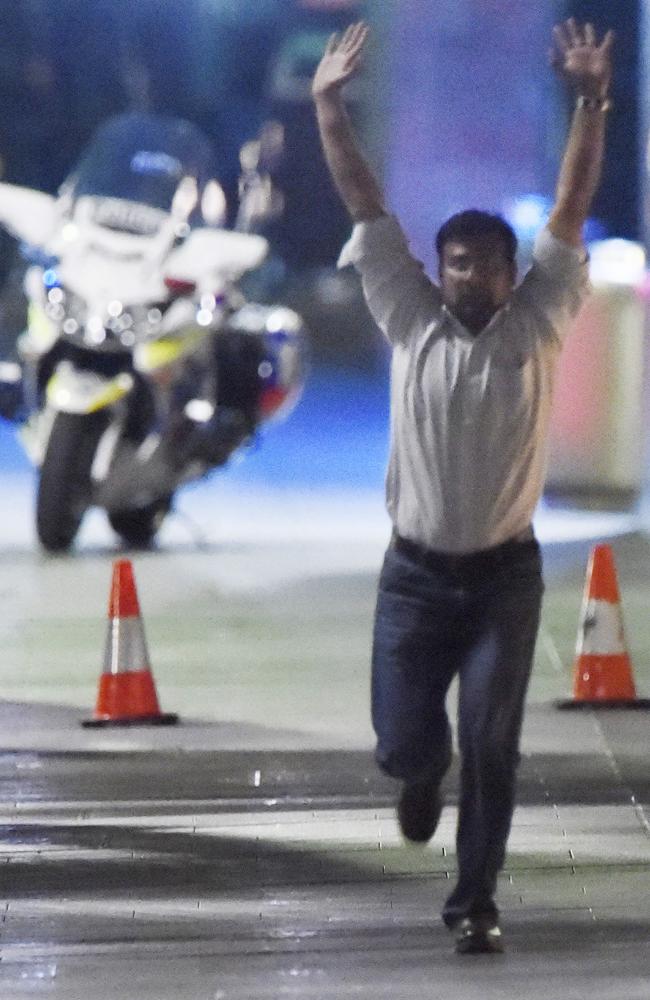 Puspendu Ghosh runs from the Lindt shop in Martin Place at the end of the siege. Picture: Gordon McComiskie