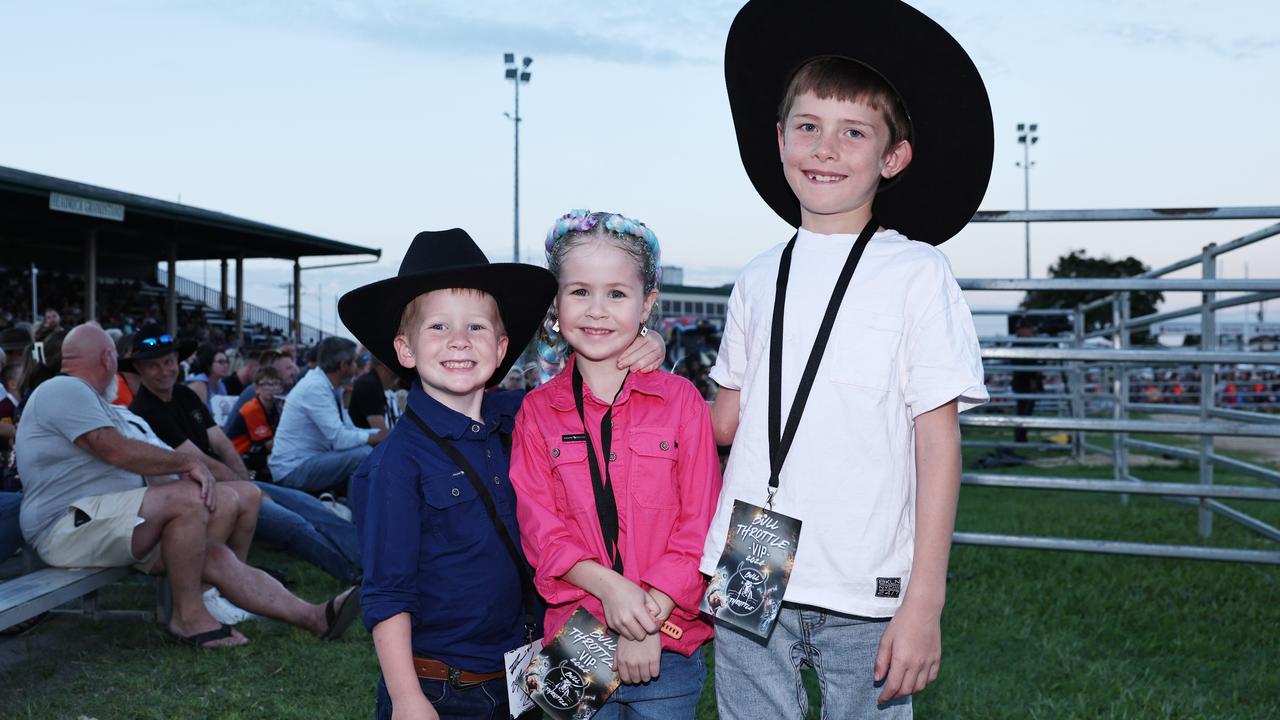 Arlo Spear, 4, Scarlett Spear, 6, and Ilija Towers, 7, attend the 2024 Cairns Bull Throttle event, a bikes and bulls show, featuring bull riding and freestyle motorcross ridiers at the Cairns Showgrounds. Picture: Brendan Radke