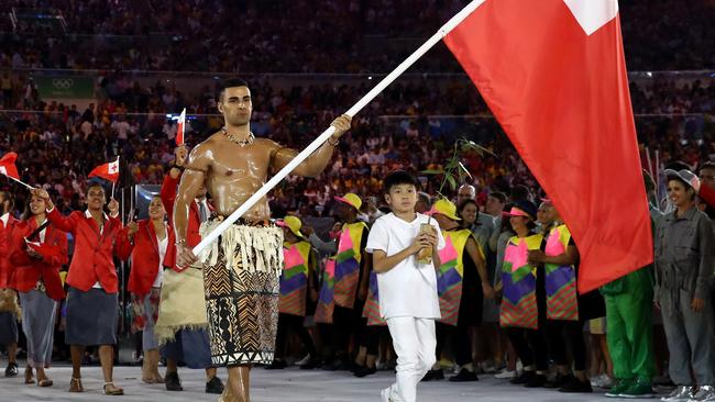 The shirtless flag bearer from Tonga has set the social world into overdrive. Picture: Cameron Spencer/Getty Images.