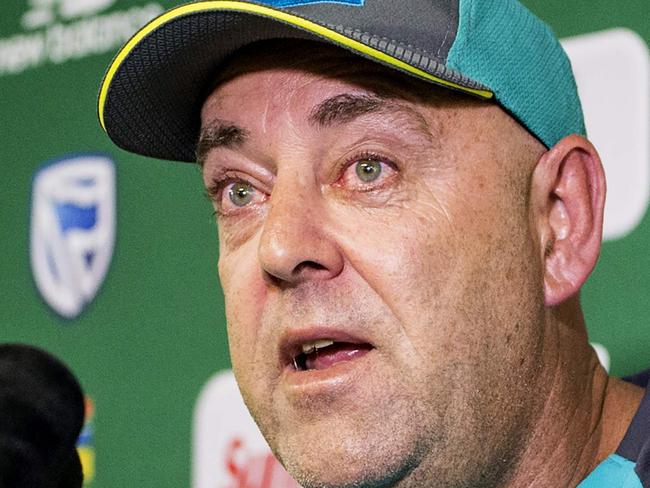 Head Coach of the Australia cricket team Darren Lehmann wipes his eyes as he responds to questions during a press conference in Johannesburg on March 29, 2018 at which he announced his resignation after the forthcoming Test match against South Africa.   Australia cricket coach Darren Lehmann said on March 29, 2018 he would quit after the final match of the scandal-tainted Test series in South Africa after the team's former captain Steve Smith broke down in tears and accepted complete responsibility for the ball-tampering incident. / AFP PHOTO / WIKUS DE WET