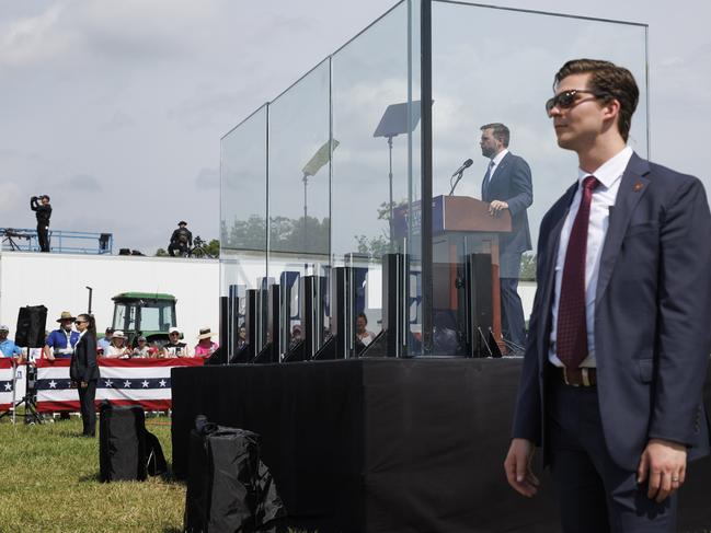 BIG RAPIDS, MI, AUGUST 27: Vice Presidential nominee Senator JD Vance (R-OH) speaks on stage behind bullet proof glass, during a campaign event in Big Rapids, Michigan, on August 27, 2024. (Photo by Tom Brenner for The Washington Post via Getty Images)