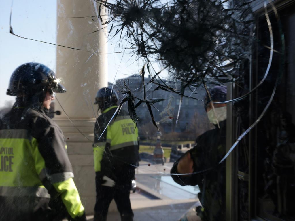 Members of US Capitol Police inspect a damaged entrance of the building on January 71 in Washington, DC. Picture: Alex Wong/Getty Images/AFP