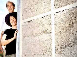 Alternative builders Patricia Schmidt and Graham Sippo of Larnook using secret hemp mixture to fill the wall cavities of their home before rendering it to improve its liveability. Picture: Jay Cronan