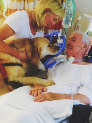 Kerri-Anne with Jon and their dog, Digger, in hospital in April. Picture: Instagram.
