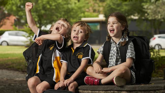 Ready to roar: Alex, 5, Teddy, 5, and Eva, 5, in Hazelwood Park, ahead of their first day of school on February 2. Picture: Matt Loxton