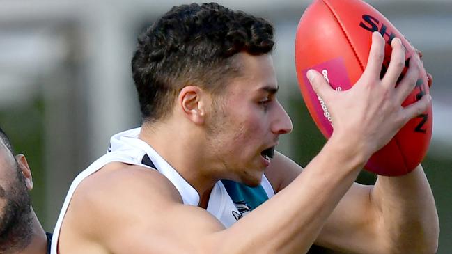 Anthony Prestia of Hillside is tackled during the round two EDFL Strathmore Community Bank Division One Seniors match between West Coburg and Hillside at Shore Reserve, on April 20, 2024, in Melbourne, Australia. (Photo by Josh Chadwick)