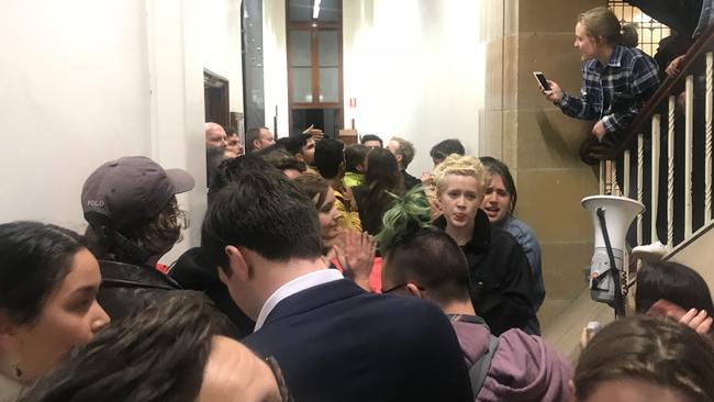 Protestors block the entrance to a talk by Bettina Arndt at Sydney University.