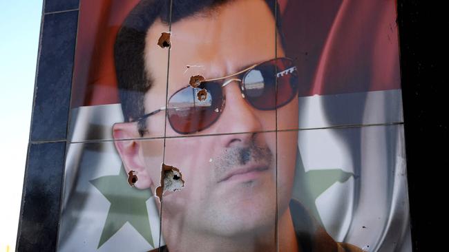 A bullet-riddled portrait of Syrian President Bashar al-Assad at the Kweyris military airfield in the eastern part of Aleppo province on December 3, 2024. Picture: Rami al Sayed/AFP