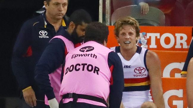 SORE POINT: Crows vice-captain Rory Sloane gets treatment after aggravating a knee injury against Essendon. Picture: Scott Barbour (AFL Media/Getty Images).