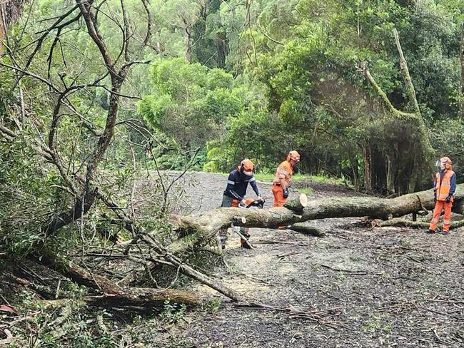 Emergency services are searching for people after a vehicle was swept through floodwaters overnight as Sydney was bashed with a wild storm, leaving thousands without power. The heavy rainfall, which started shifting north towards the MId North Coast and into Queensland, left a barrage of damage in its wake as gale force winds and sheets of rain battered pockets of the state overnight. In the span of 24 hours, nearly 1,700 calls were made the NSW SES, 890 of which were made inside the metro area of Sydney. Two people from Bulahdelah called emergency services after becoming trapped inside their vehicles, which got caught in rising waters, and another man in Mount George required assistance after becoming trapped in flood waters, leaving him with no choice but tos it on the roof of his car until he was rescued. Picture: Facebook