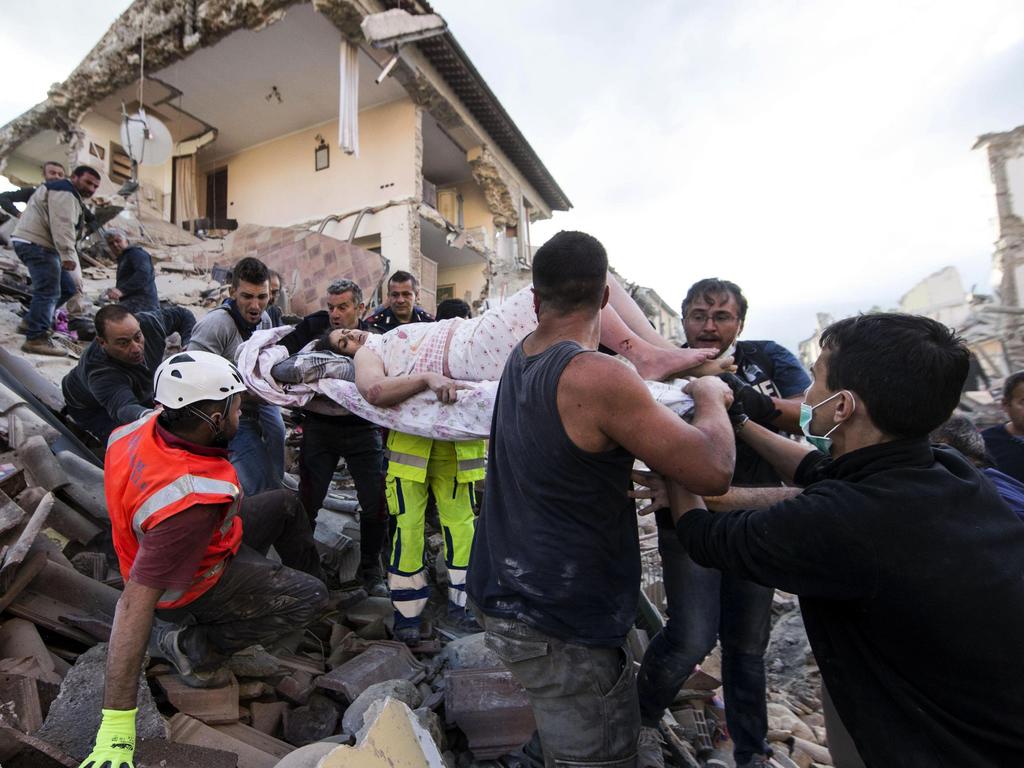 A rescued woman is carried away on a stretcher following an earthquake in Amatrice Italy, on August. 24, 2016. Picture: AP