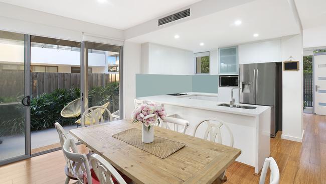 A tidy kitchen and dining area has a nice outdoor flow.