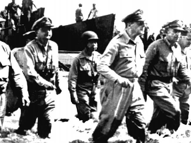 US General Douglas MacArthur wades ashore on Leyte Island.