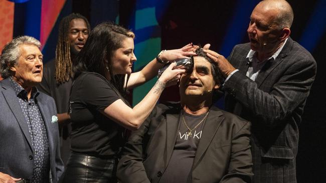 Tony Galati gets his eyebrows shaved.