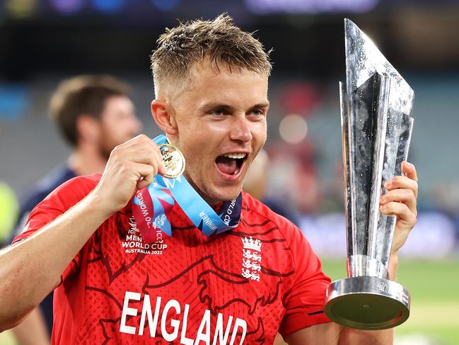 MELBOURNE, AUSTRALIA - NOVEMBER 13:  Sam Curran of England poses with the trophy as they celebrate victory in the ICC Men's T20 World Cup Final match between Pakistan and England at the Melbourne Cricket Ground on November 13, 2022 in Melbourne, Australia. (Photo by Mark Kolbe/Getty Images)