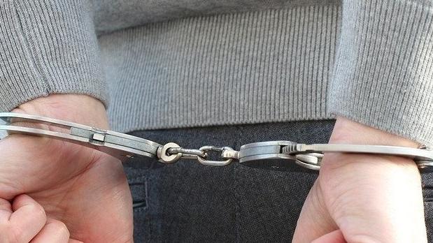 Generic picture of handcuffs of person being arrested.