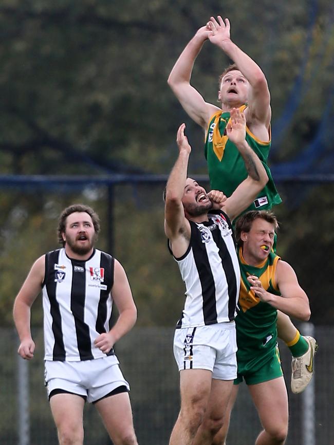 Leongatha’s Guy Dickson soars over Sale’s Jack Johnstone. Picture: Yuri Kouzmin