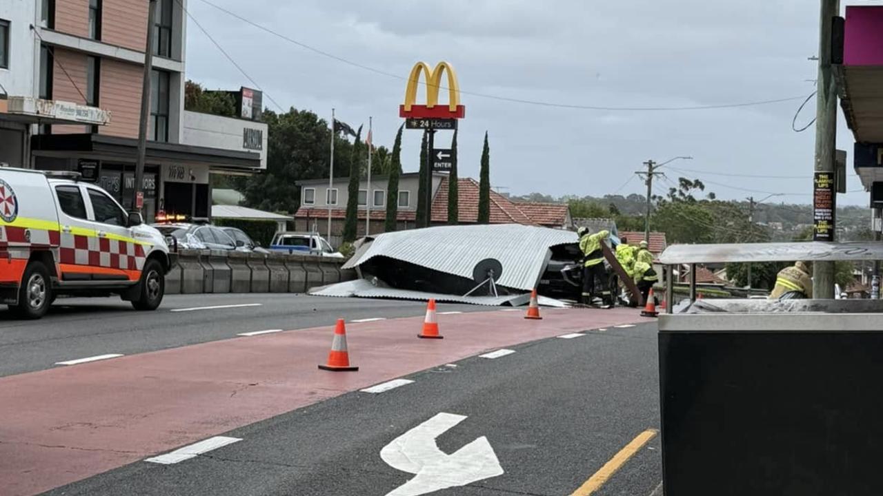 A major road in Sydney has been closed, with multiple cars trapped and one person injured after a roof was blown off a shop and onto the road in Drummoyne. Picture: Facebook