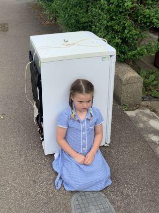 A mum took a passport photo of her daughter in front on the of their discarded fridge on the footpath. Source: Kennedy News