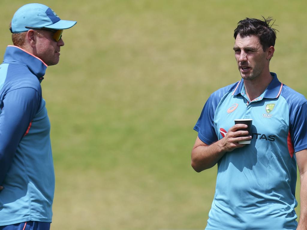 Australian coach Andrew McDonald and captain Pat Cummins discuss plans in Wellington. Picture: Hagen Hopkins/Getty Images