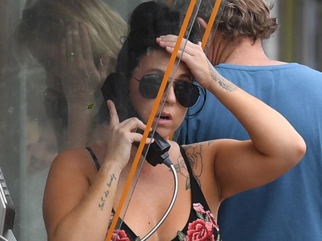 Locals queue to use a public phone in Airlie Beach, Wednesday, March 29, 2017. Cyclone Debbie has hit Queensland's far north coast yesterday as a category 4 cyclone, causing wide spread damage. (AAP Image/Dan Peled) NO ARCHIVING