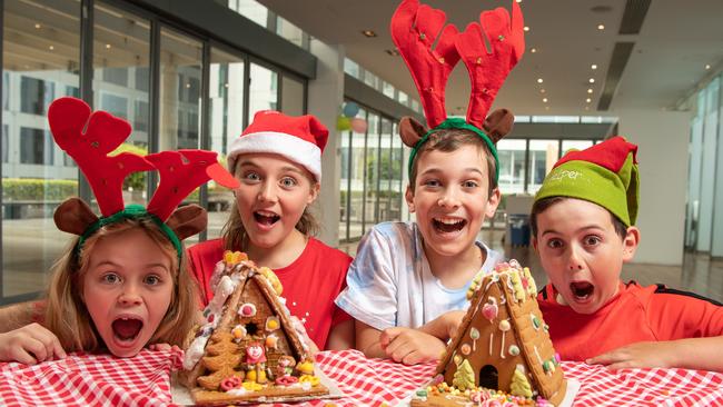 Ruby Schipper, 7, Lilly Schipper, 10, Trent Farrell, 11, and Luca D’Aloia, 11, with the last houses standing – by Aldi, left, and David Jones. Picture: Brad Fleet