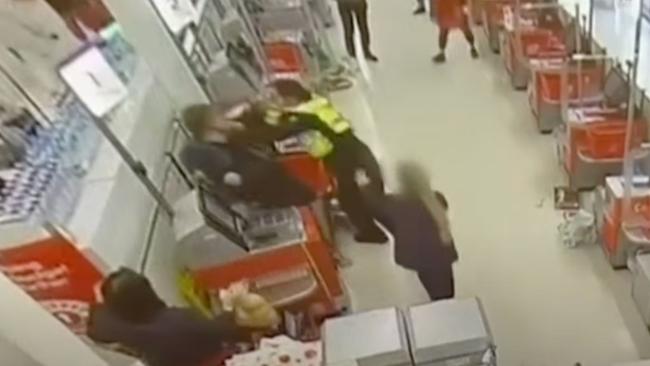 The security guard threw the man into the check-outs as a manager came to intervene. Picture: Channel 7 / 7 News