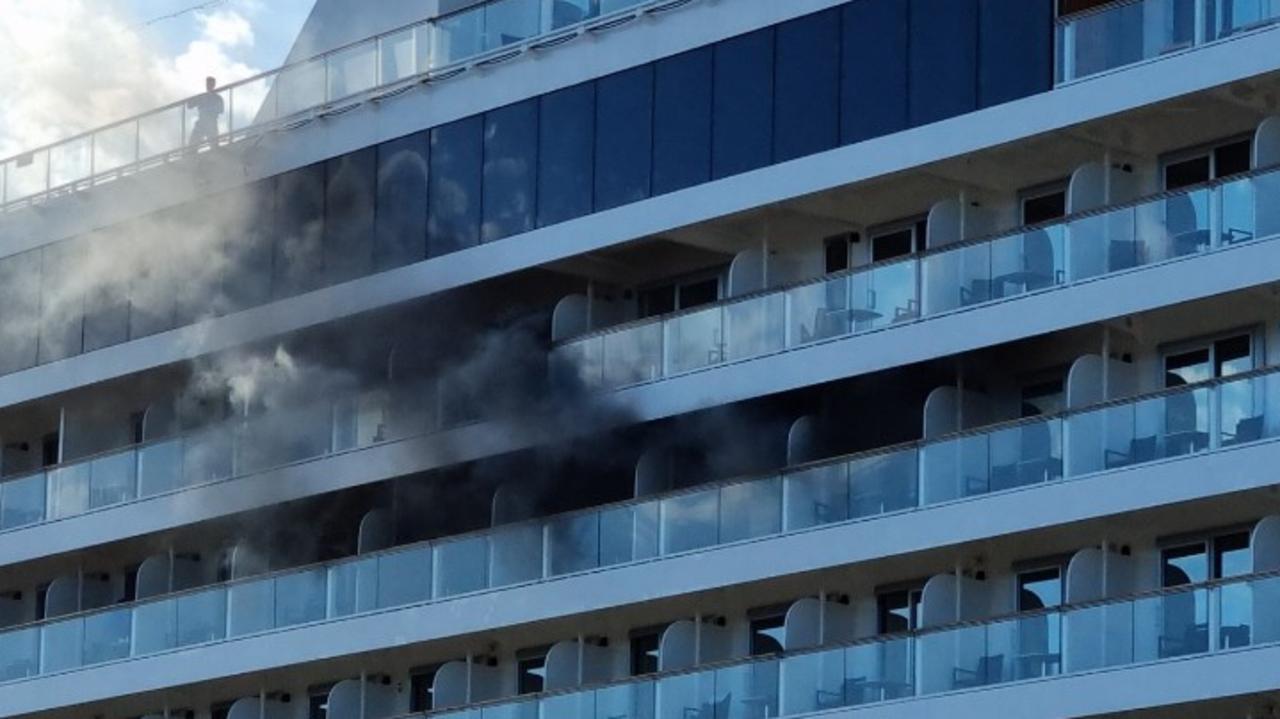 Smoke billows from the window the cruise ship. Picture: Supplied via NCA NewsWire