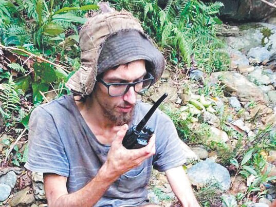 Andrew Gaskell talks to his father to tell him that he is alive, after being found in the Malaysia jungle. MUST CREDIT: Sarawak Fire and Rescue department