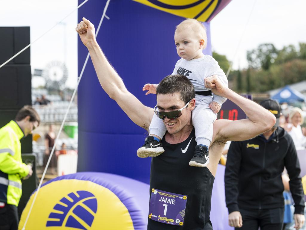 Toowoomba Marathon winner Jamie Lacey collected his one-year-old son Jackson Lacey before crossing the finish line, Sunday, May 5, 2024. Picture: Kevin Farmer