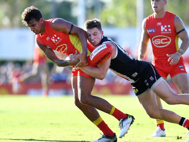 Jack Billings of the Saints (right) tackles Callum Ah Chee of the Suns during the Round 13 AFL match between the Gold Coast Suns and the St Kilda Saints at Riverway Stadium in Townsville, Saturday, June 15, 2019. (AAP Image/Dan Peled)