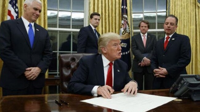 Donald Trump in the Oval Office with members of his administration..